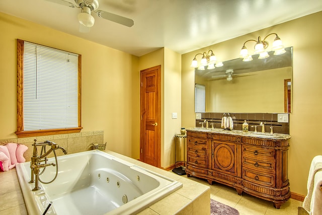 full bath featuring a sink, a ceiling fan, double vanity, a tub with jets, and tile patterned flooring