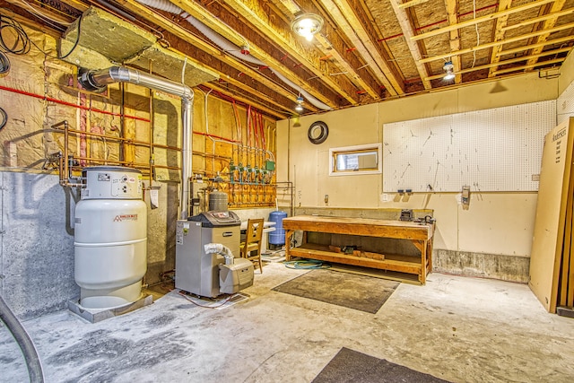 unfinished below grade area featuring a workshop area and a heating unit