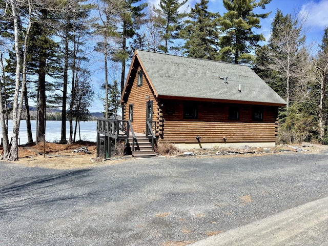 106 N Birch St, Greenville, ME 04441 - view of side of property with log exterior, a water view, and roof with shingles