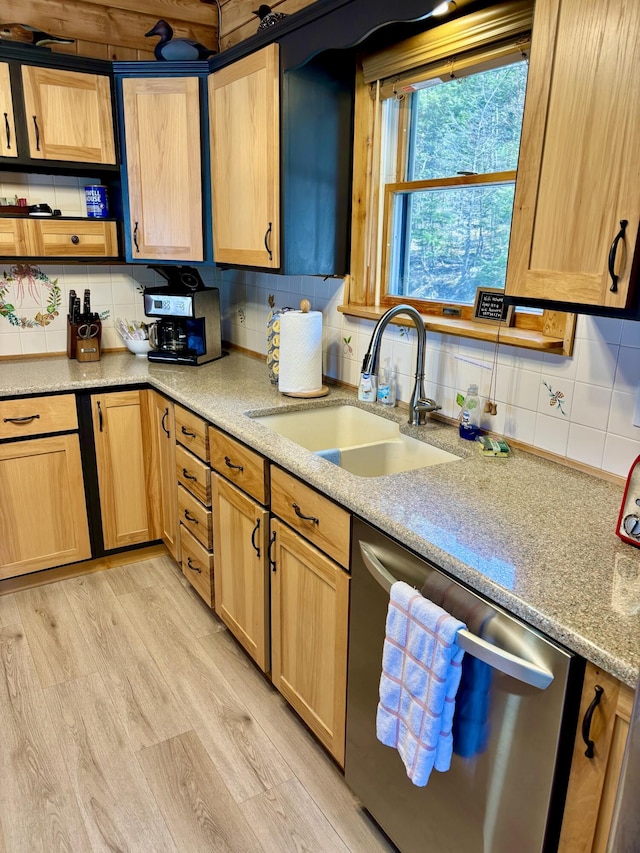 106 N Birch St, Greenville, ME 04441 - kitchen with stainless steel dishwasher, a sink, decorative backsplash, light brown cabinets, and light stone countertops