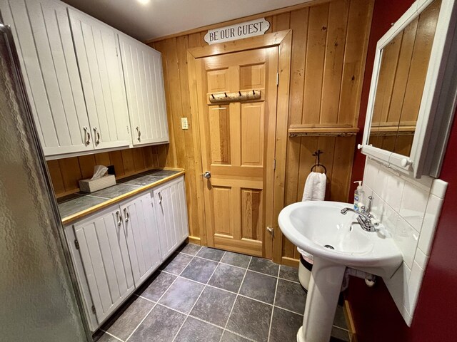106 N Birch St, Greenville, ME 04441 - bathroom with wooden walls and tile patterned flooring