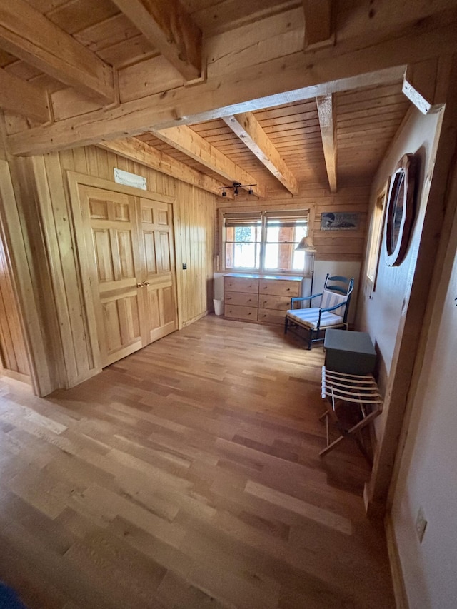 106 N Birch St, Greenville, ME 04441 - living area with beamed ceiling, wood finished floors, wooden ceiling, and wooden walls