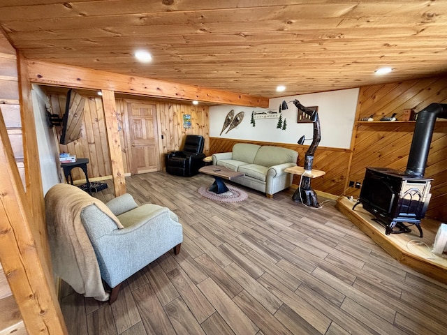 106 N Birch St, Greenville, ME 04441 - living room with wooden walls, wood ceiling, a wood stove, and wood finished floors