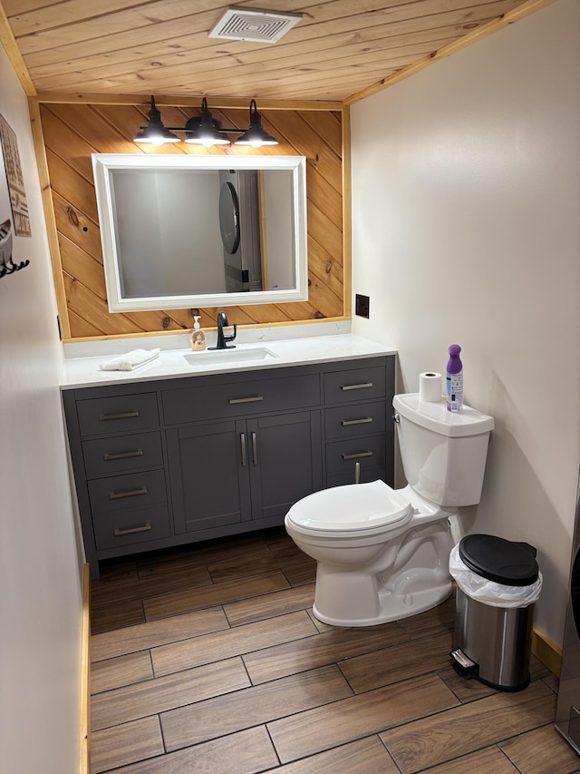 106 N Birch St, Greenville, ME 04441 - bathroom with wooden ceiling, toilet, wood finished floors, and vanity
