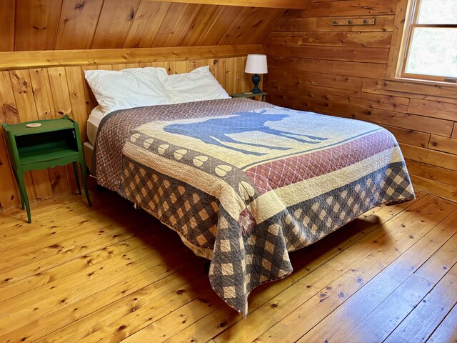 106 N Birch St, Greenville, ME 04441 - bedroom featuring hardwood / wood-style floors, wooden walls, lofted ceiling, and wooden ceiling