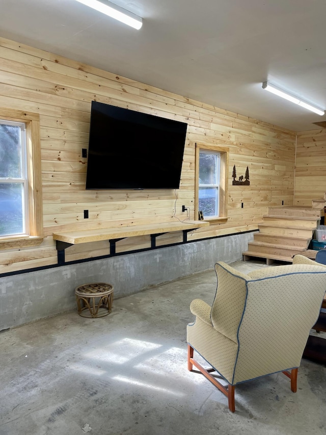 106 N Birch St, Greenville, ME 04441 - living area featuring wooden walls and concrete flooring