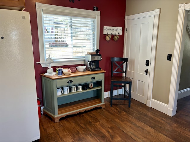interior space with baseboards and dark wood-style floors