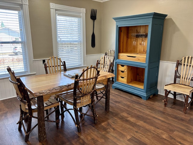 dining space featuring plenty of natural light, dark wood-style floors, and wainscoting