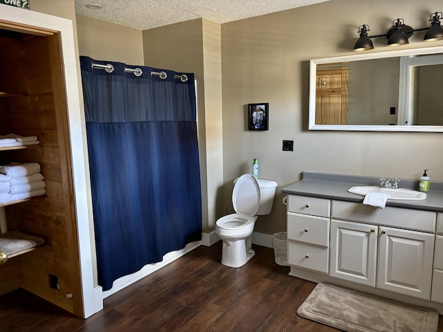 bathroom with wood finished floors, a textured ceiling, vanity, and a shower with curtain