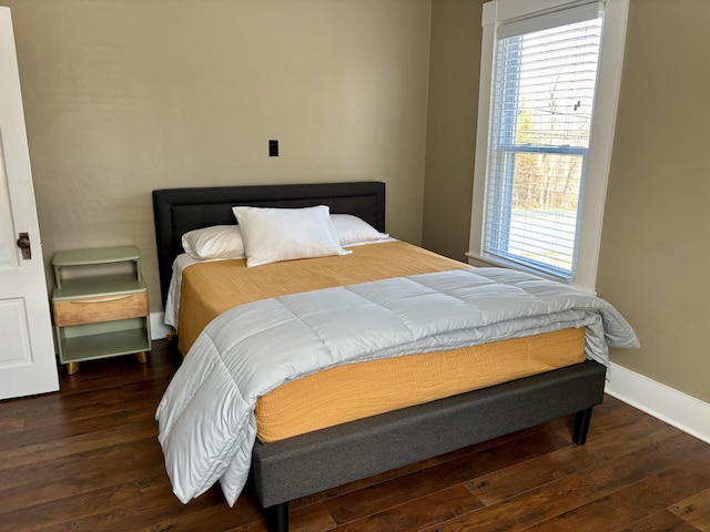 bedroom with baseboards and wood-type flooring