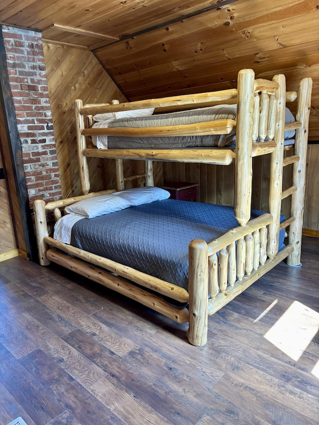 bedroom featuring lofted ceiling, wood finished floors, wood walls, and wooden ceiling