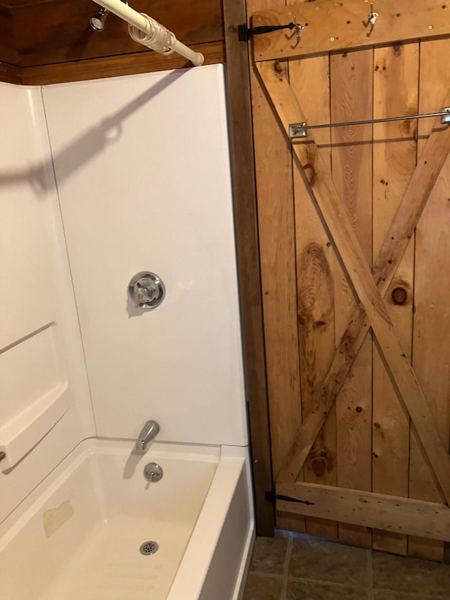 bathroom featuring tile patterned flooring and shower / tub combination