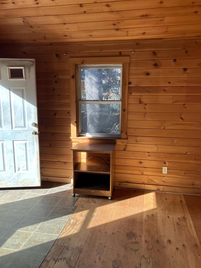 interior space featuring wood walls and hardwood / wood-style flooring