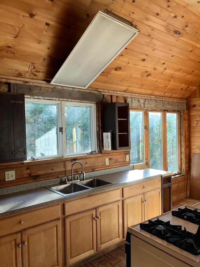 kitchen with a sink, wooden ceiling, white range with gas stovetop, and a healthy amount of sunlight