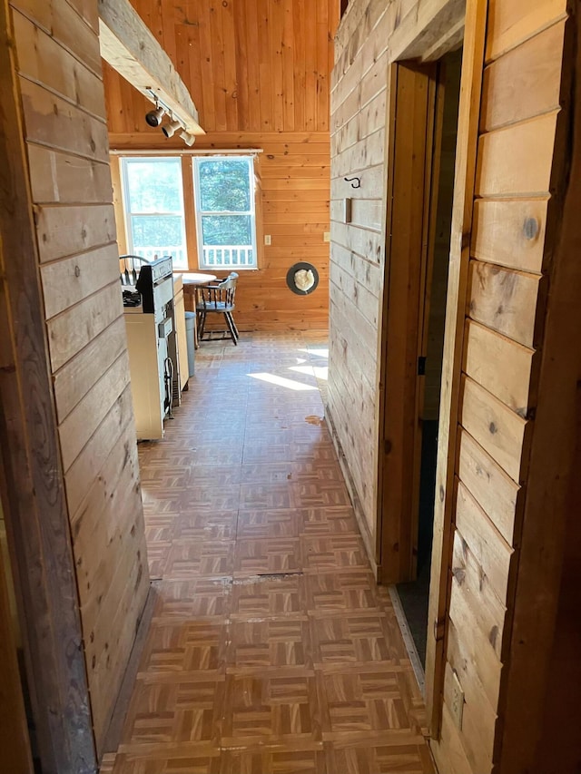 corridor featuring wooden walls