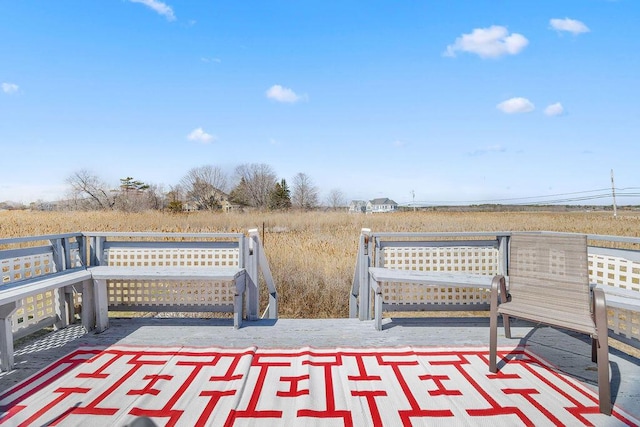wooden terrace featuring a rural view