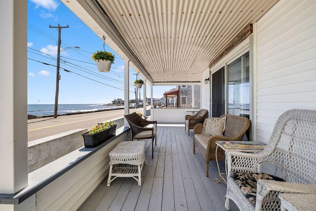 deck featuring a porch and a water view