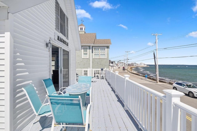 wooden deck featuring a water view