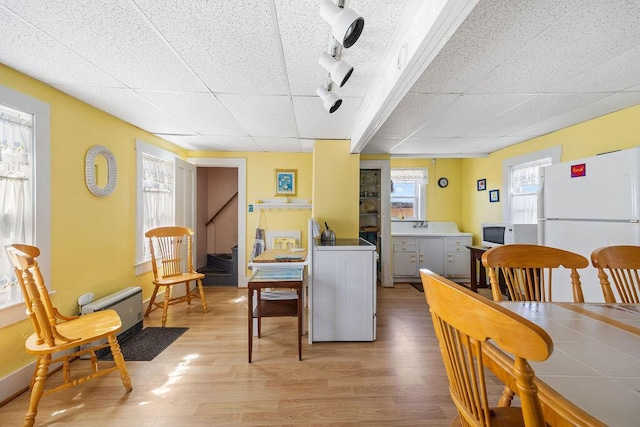 dining room with light wood-style floors and washer / dryer