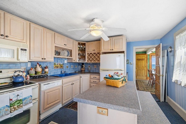 kitchen with light brown cabinets, a sink, white appliances, a kitchen island, and ceiling fan