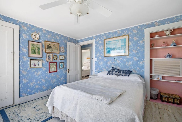 bedroom featuring wallpapered walls, a ceiling fan, and baseboards