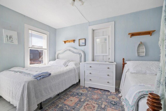 bedroom with wallpapered walls