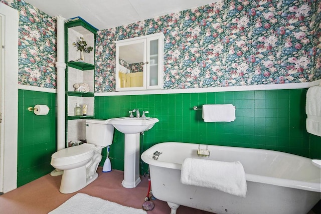 bathroom with wainscoting, wallpapered walls, and toilet