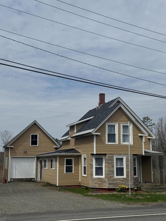 432 Hartland Ave, Pittsfield, ME 04967 - view of front facade featuring a chimney, driveway, and an outdoor structure
