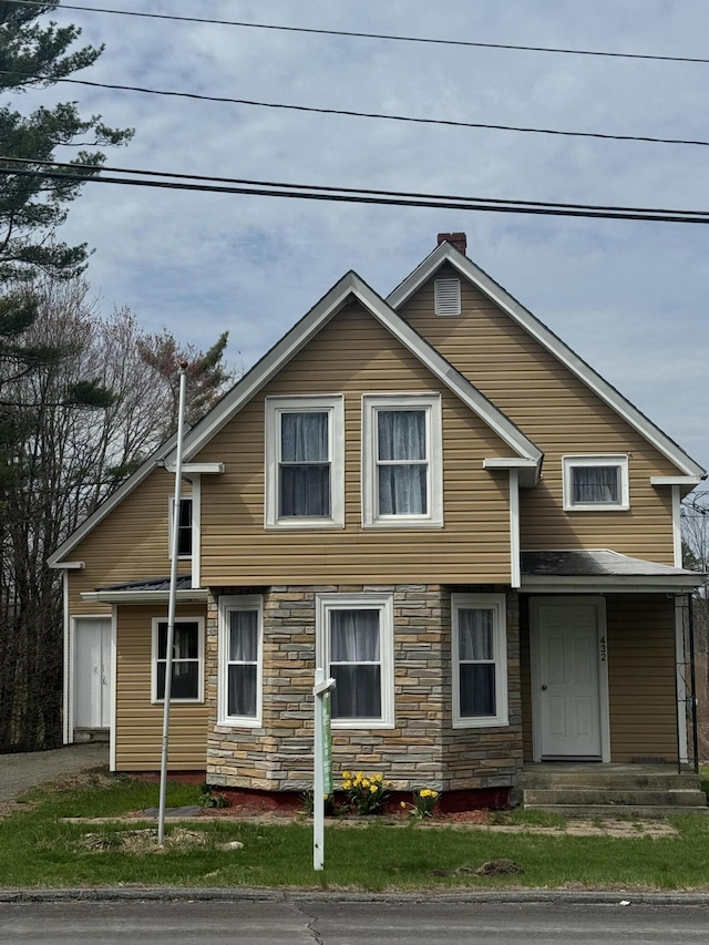432 Hartland Ave, Pittsfield, ME 04967 - view of front of home with stone siding and a chimney