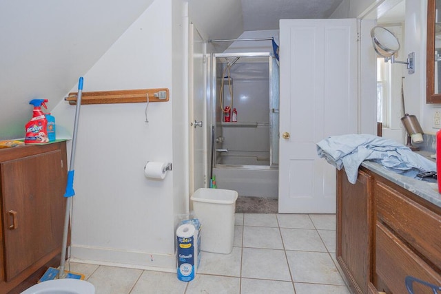 full bath featuring combined bath / shower with glass door, vanity, and tile patterned flooring