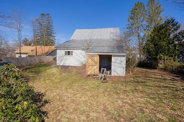 exterior space with fence and a lawn