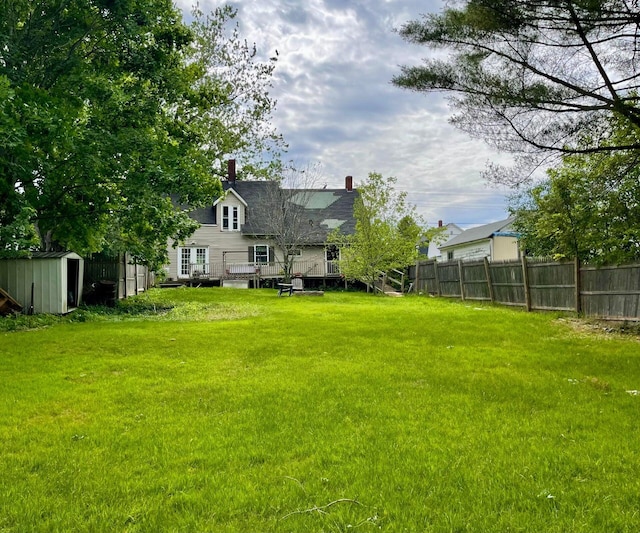 642 Main St, Old Town, ME 04468 - view of yard with a deck, an outbuilding, a shed, and fence