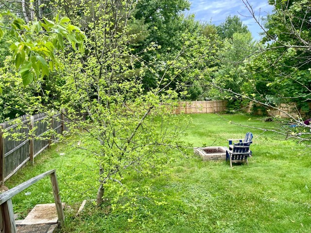 642 Main St, Old Town, ME 04468 - view of yard featuring an outdoor fire pit and a fenced backyard