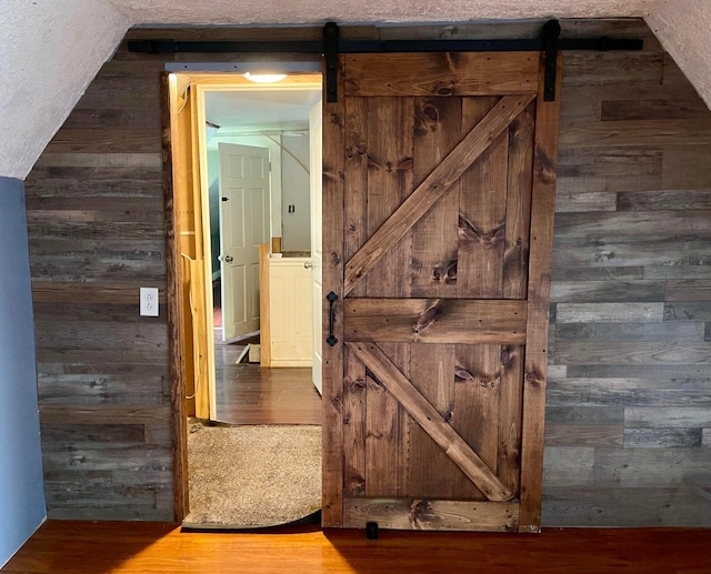 642 Main St, Old Town, ME 04468 - hall featuring a barn door, wooden walls, and wood finished floors