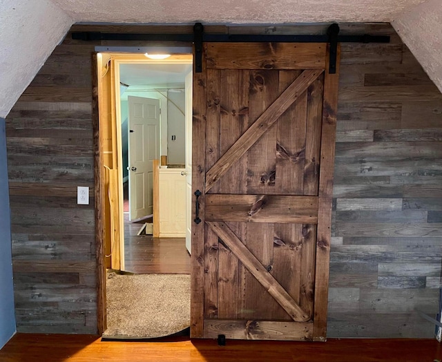 642 Main St, Old Town, ME 04468 - hall with wood finished floors, wooden walls, and a barn door