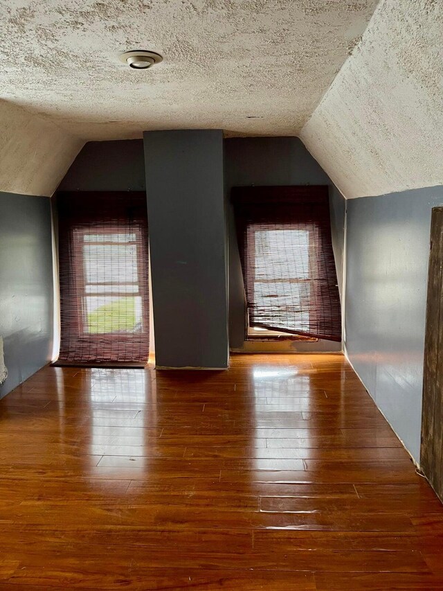 642 Main St, Old Town, ME 04468 - bonus room featuring a textured ceiling, wood-type flooring, lofted ceiling, and a wealth of natural light