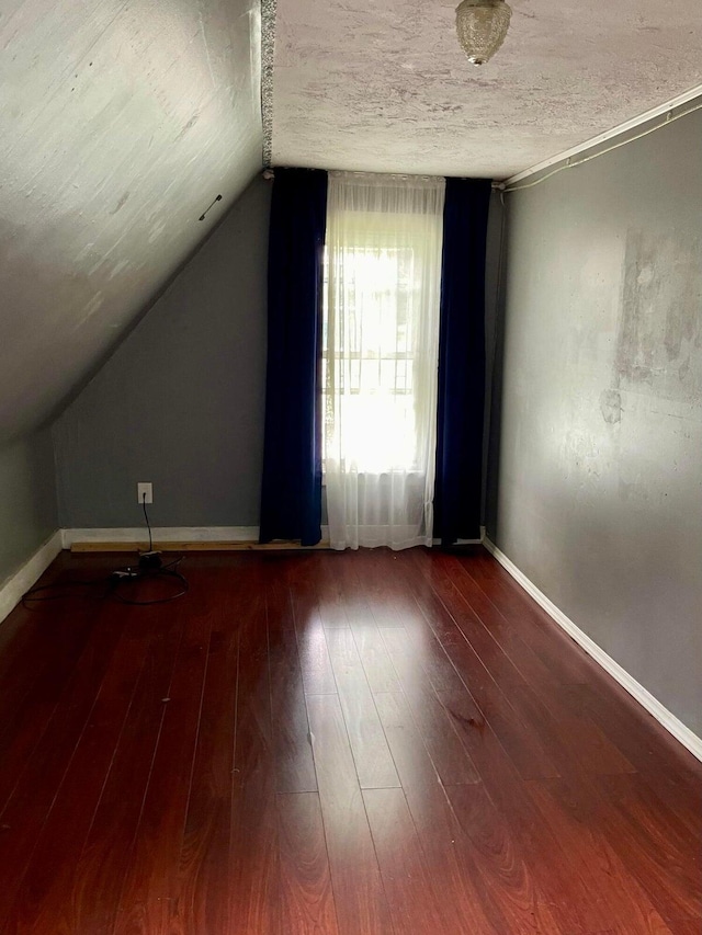 642 Main St, Old Town, ME 04468 - bonus room with wood-type flooring, baseboards, lofted ceiling, and a textured ceiling