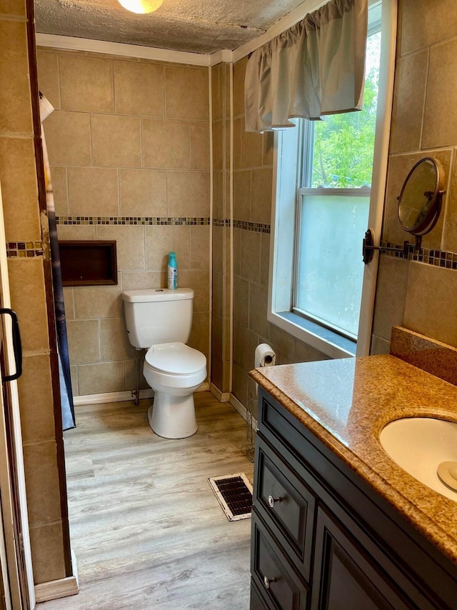 642 Main St, Old Town, ME 04468 - full bathroom featuring a textured ceiling, wood finished floors, vanity, and visible vents