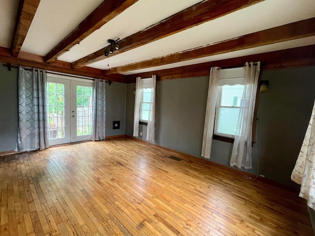 642 Main St, Old Town, ME 04468 - spare room featuring french doors, hardwood / wood-style flooring, and a healthy amount of sunlight