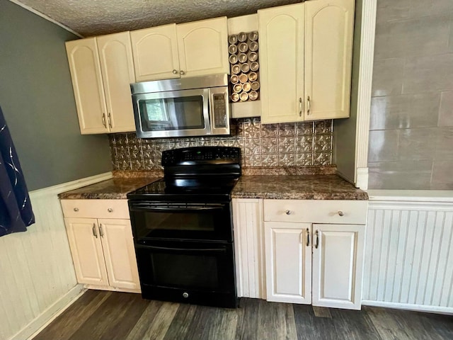 642 Main St, Old Town, ME 04468 - kitchen featuring dark wood-type flooring, stainless steel microwave, decorative backsplash, and range with two ovens