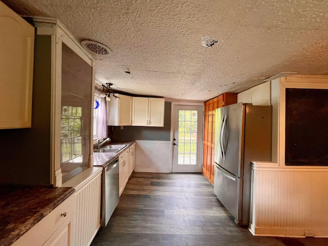 642 Main St, Old Town, ME 04468 - kitchen featuring a sink, appliances with stainless steel finishes, a textured ceiling, white cabinetry, and dark wood-type flooring