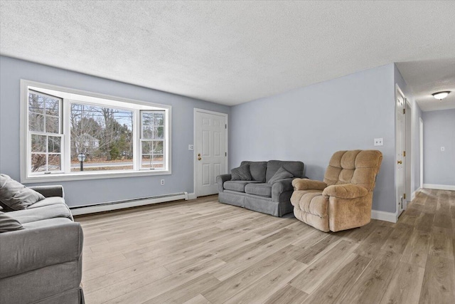 living room featuring light wood-style flooring, a baseboard radiator, and a textured ceiling