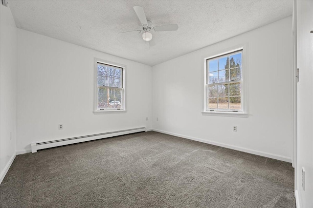 carpeted empty room with baseboards, a baseboard heating unit, ceiling fan, and plenty of natural light