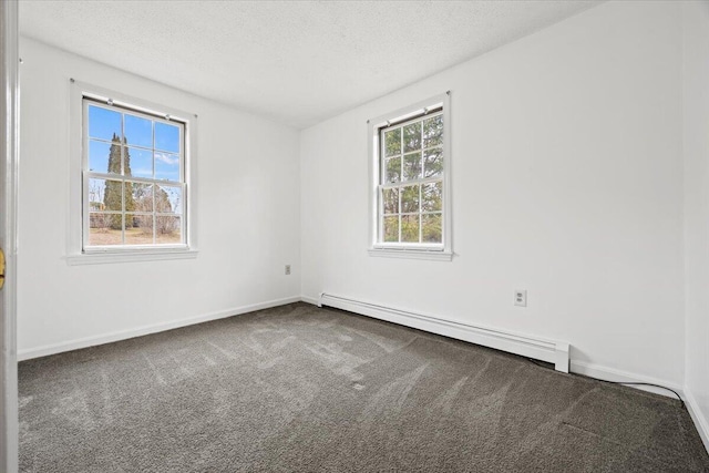 carpeted empty room with a baseboard radiator, baseboards, and a textured ceiling