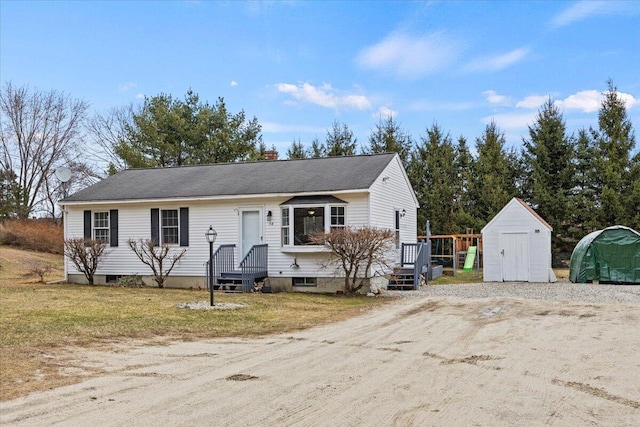 view of front of home with a storage shed and an outdoor structure