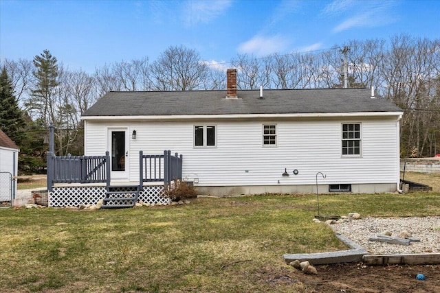 rear view of house with a wooden deck, a lawn, and a chimney