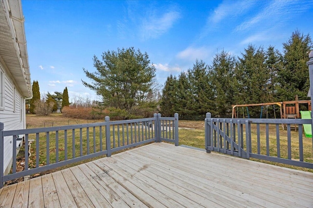 wooden deck featuring a yard and a playground