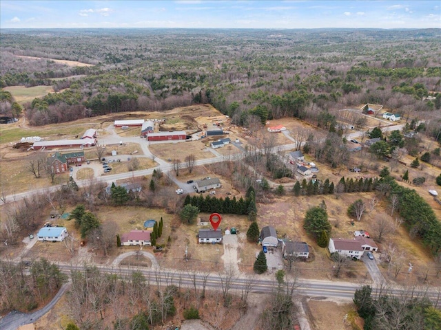 birds eye view of property featuring a wooded view