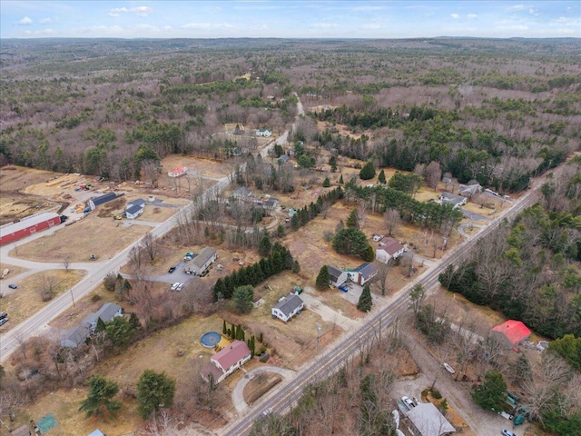 birds eye view of property with a view of trees