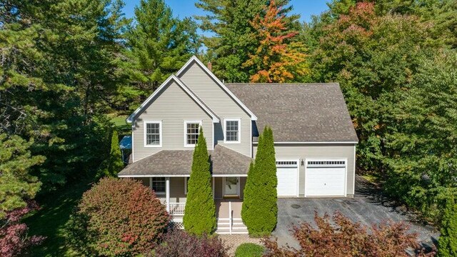 21 Oakmont Dr Unit 21, Old Orchard Beach, ME 04064 - traditional home featuring an attached garage, a shingled roof, covered porch, and driveway